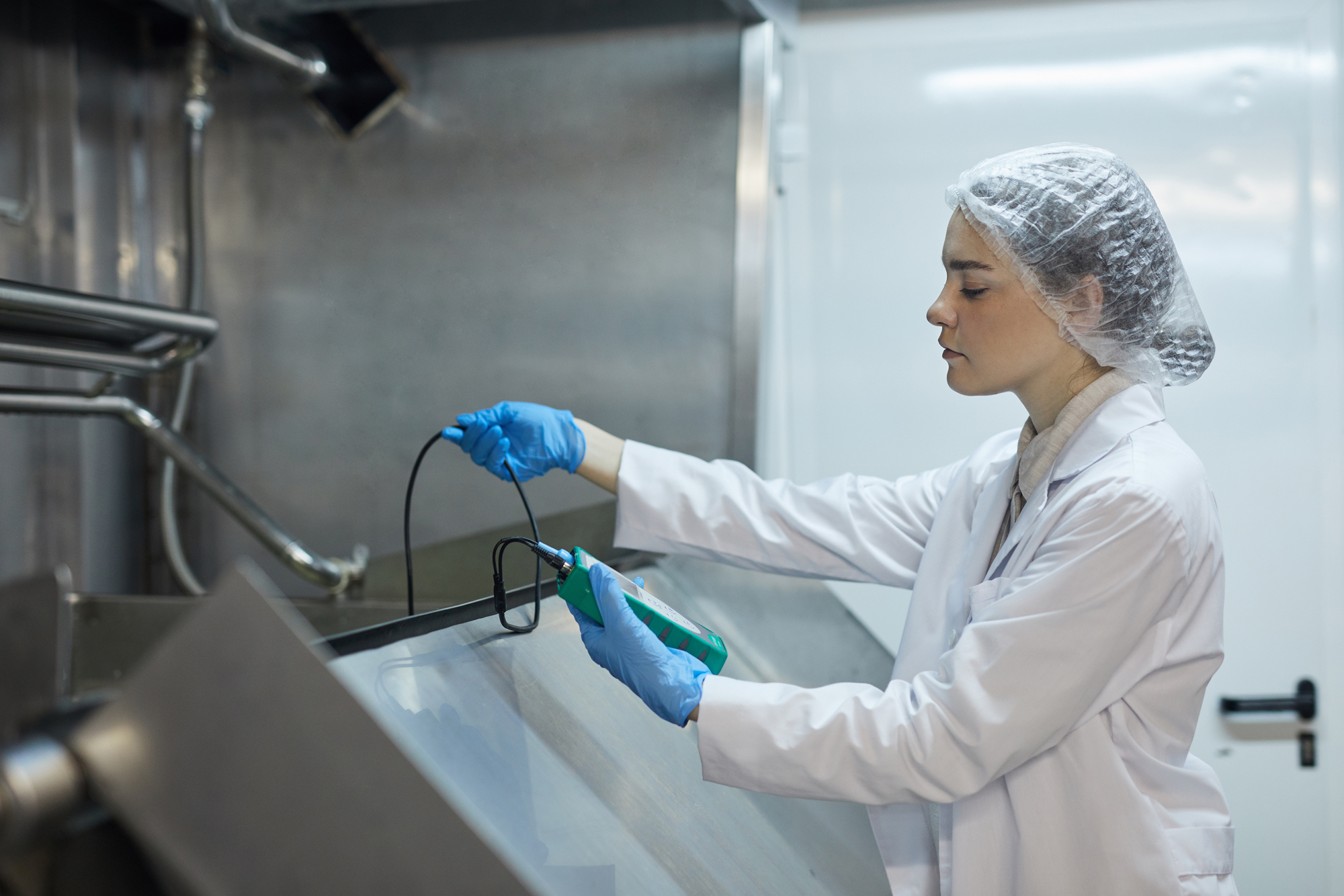 Female Worker with Hairnet Testing Sanitation of Food Item