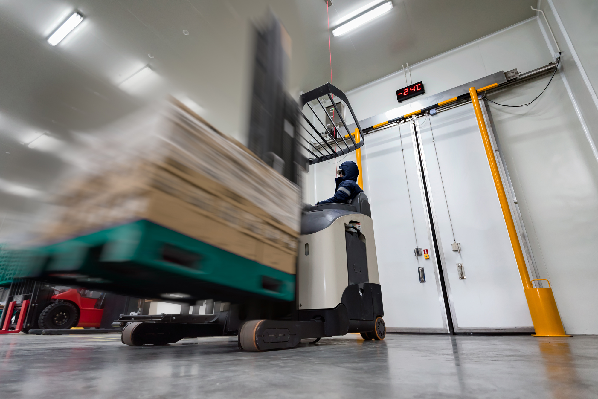 Forklift Carrying Brown Boxes in Manufacturing Plant